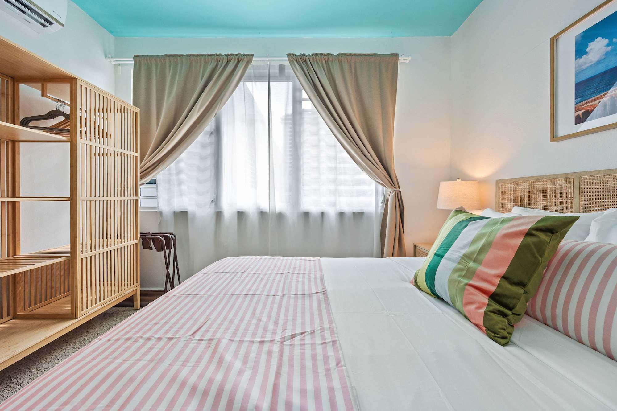 Queen bed with striped linens