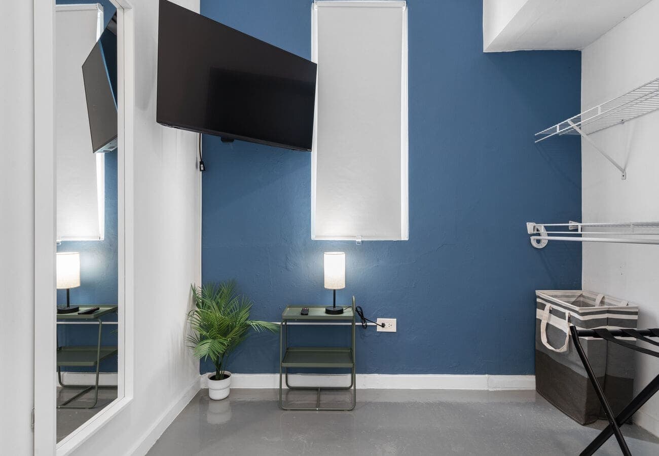 Bedroom 1 with smart TV, clothing rack & luggage stand