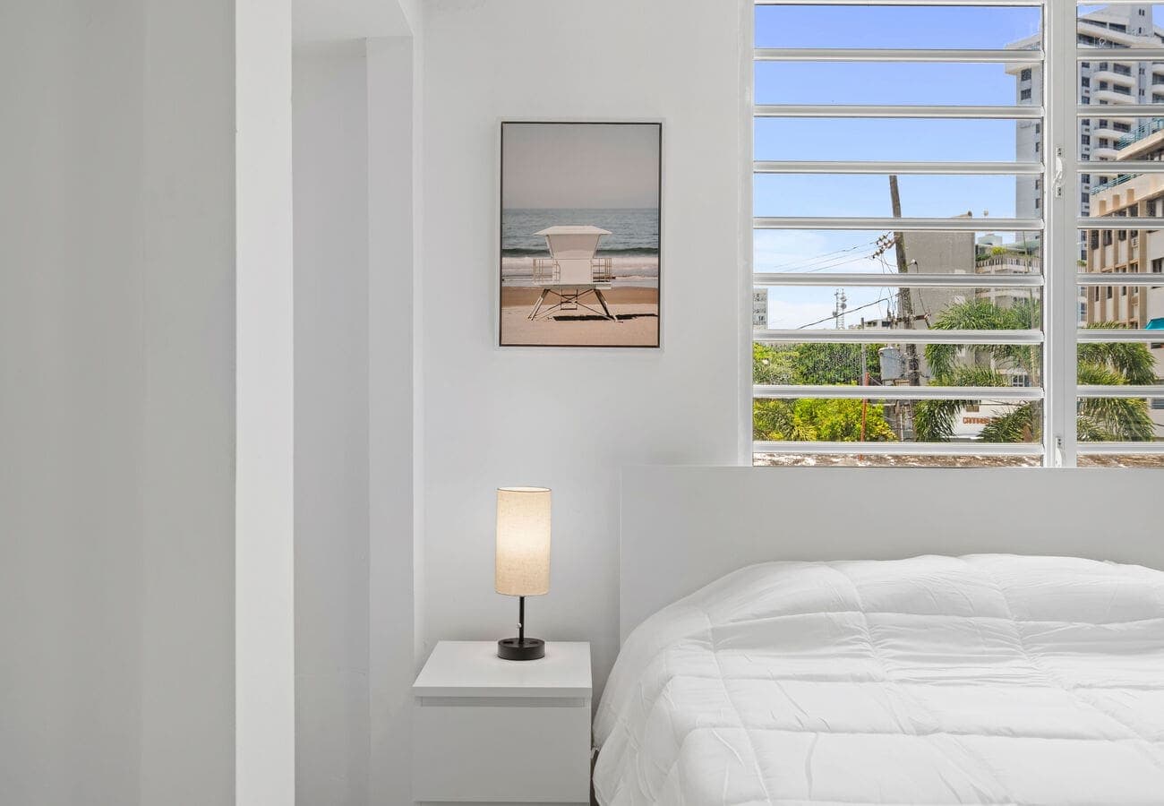 Bedside nook with beach art and city light