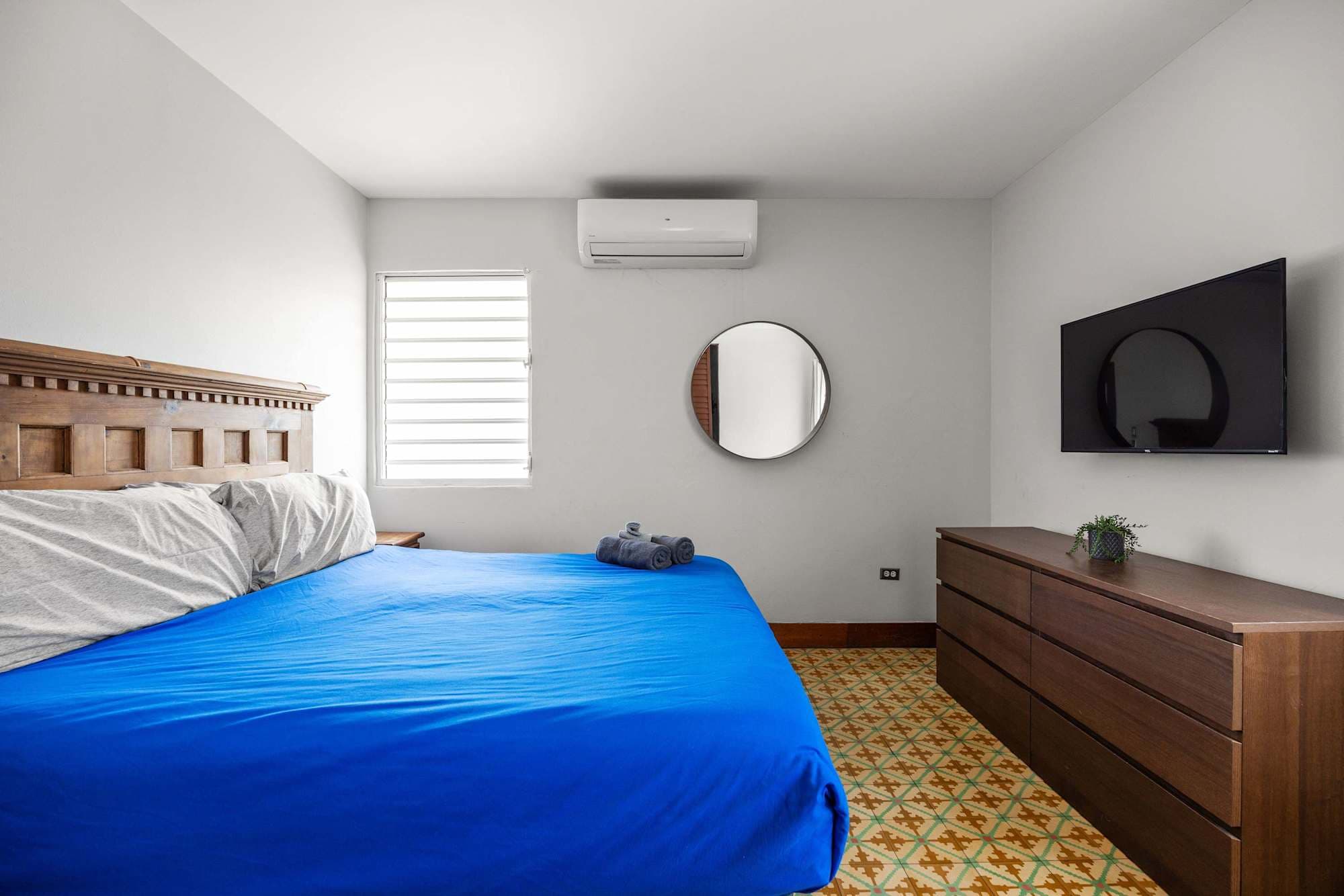 Bedroom with mirror and TV