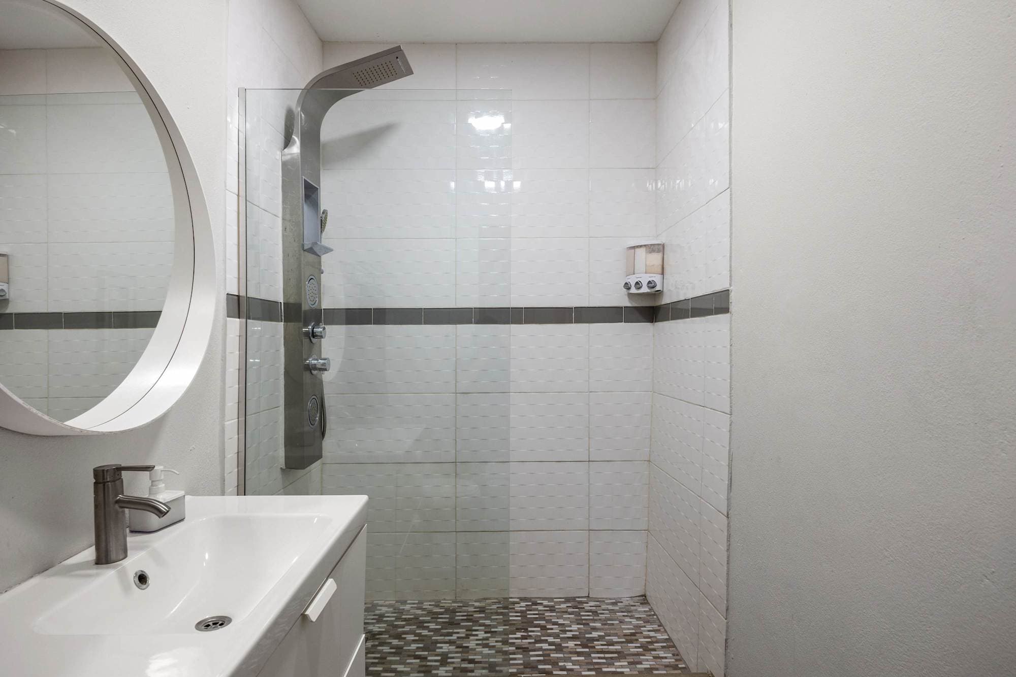 Shower area with gray tiles