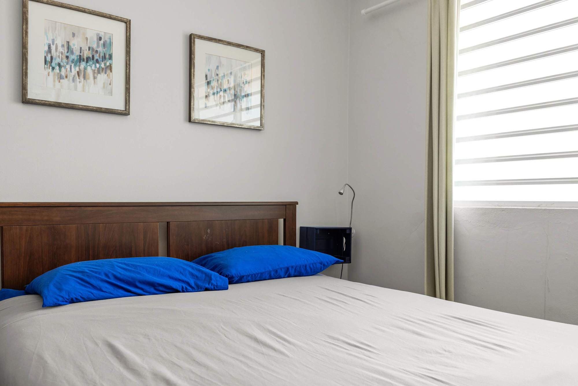 Bed against white shuttered window