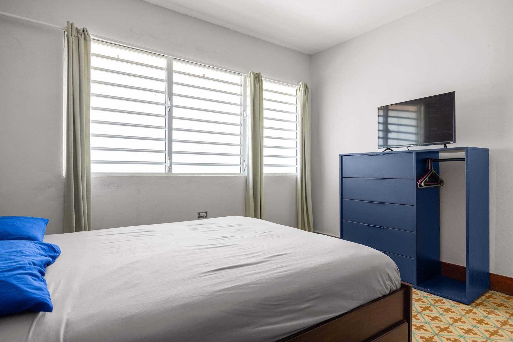 Sunlit bedroom with dresser