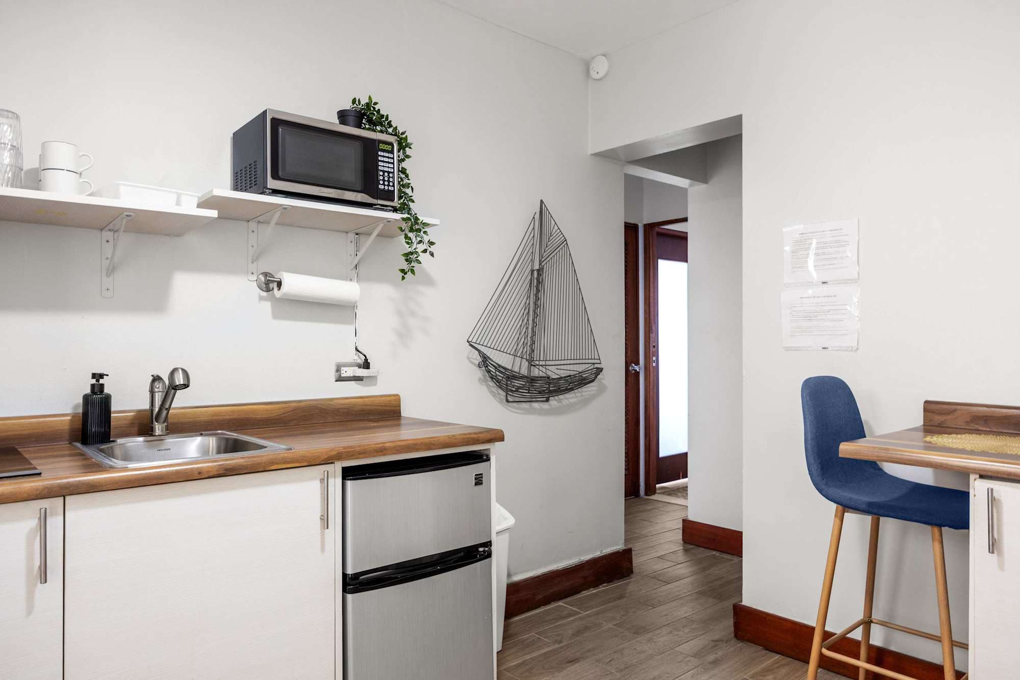Compact kDining nook with framed artitchen with mini fridge