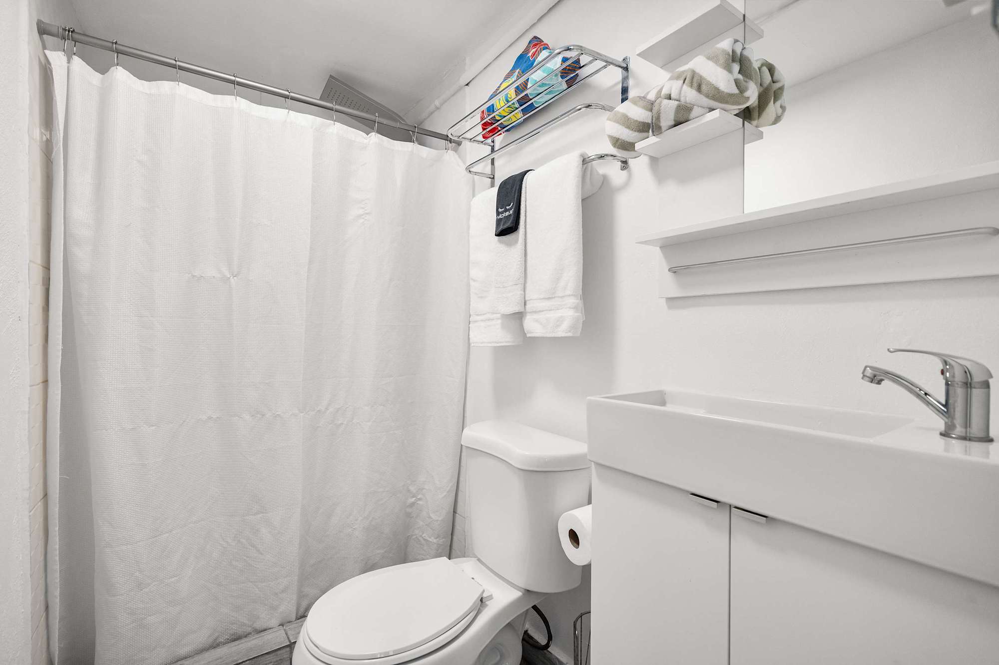 Slide open the architectural barn doors to reveal a clean, modern en-suite bathroom. Seamless privacy just steps from your bed.