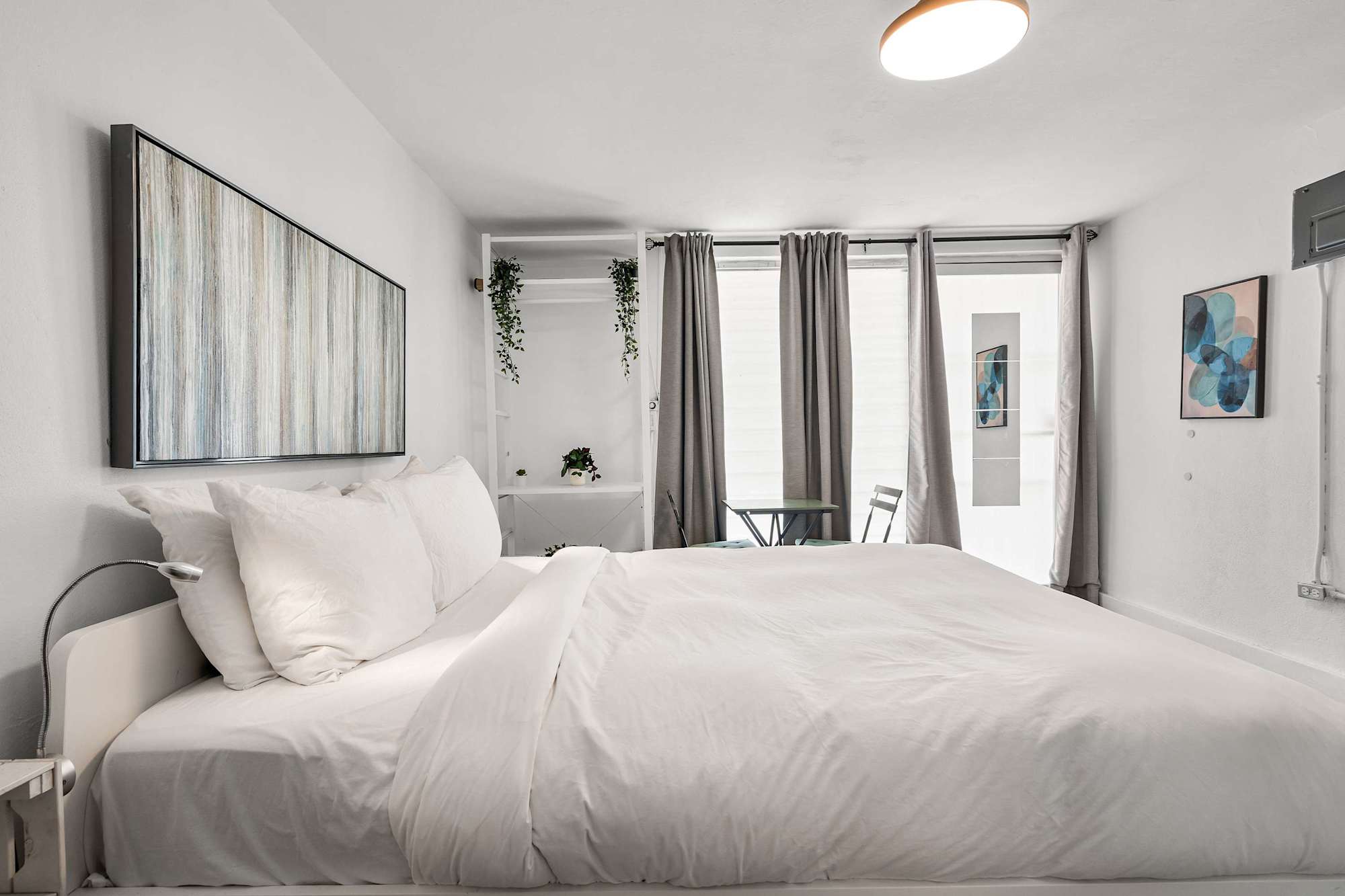 Unwind in a sleek, open-concept studio. Enjoy a plush queen bed right next to your private, fully equipped kitchenette—perfect for seamless urban living.