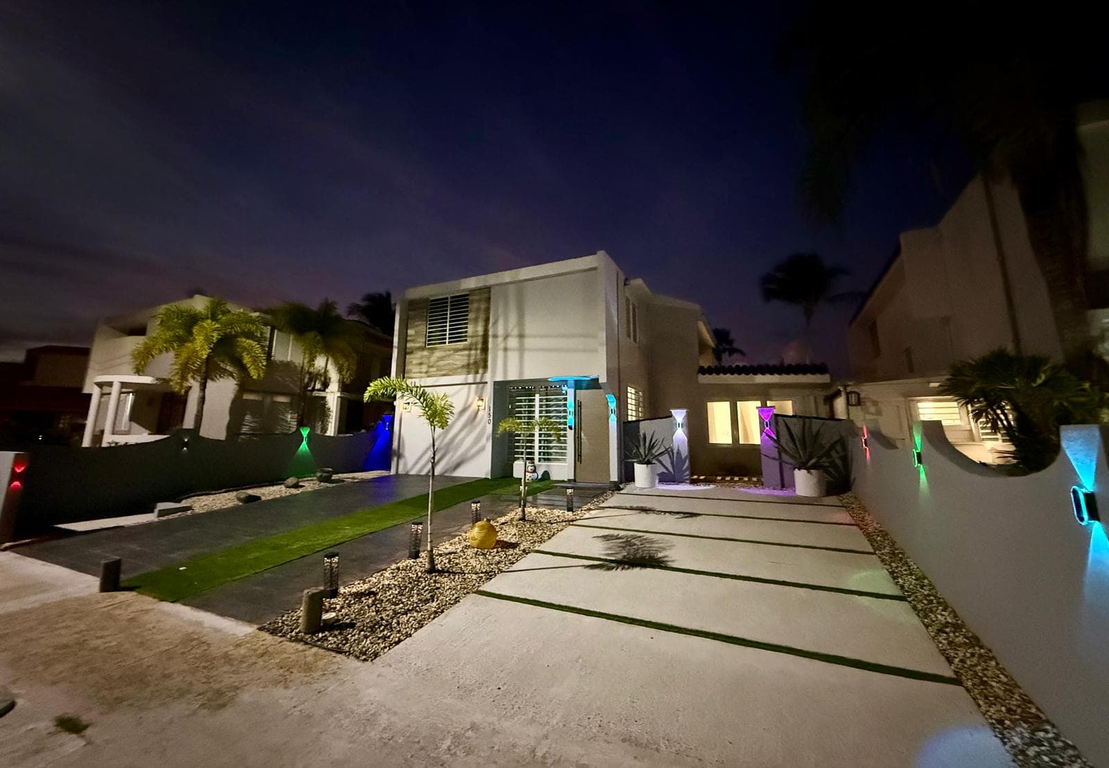 Villa exterior lit up at night