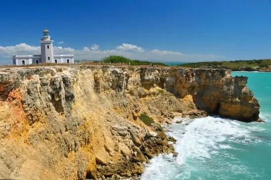 A stunning beach with clear turquoise waters and a pristine, light-colored sandy shoreline.