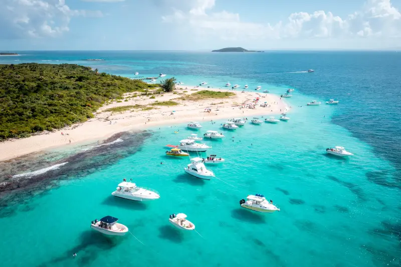 Discover vibrant coral reefs teeming with life in crystal-clear waters, all while surrounded by soft white sand.